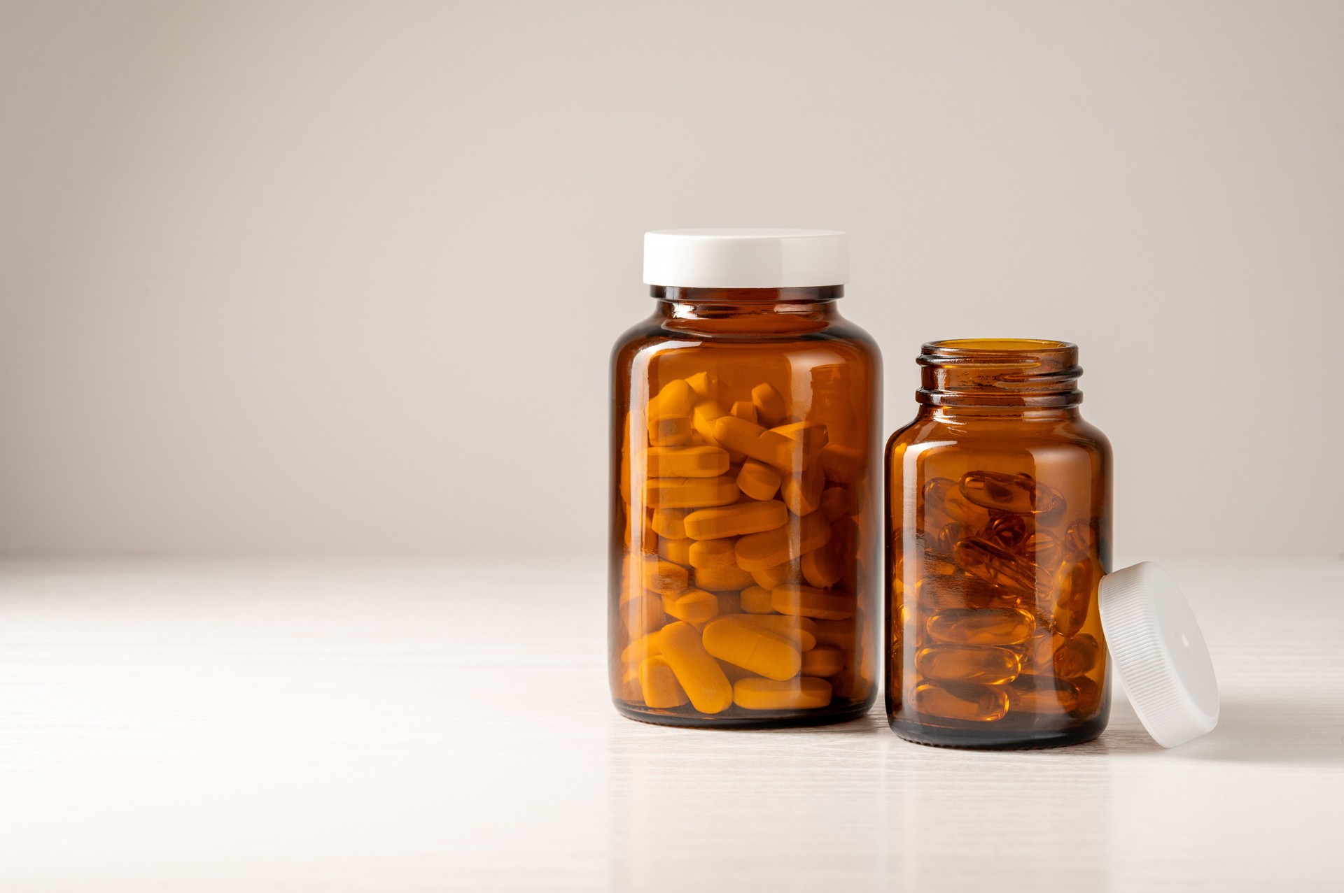 Vitamins, pills, omega 3, food supplements in  glass jar, health and wellness. Food supplement