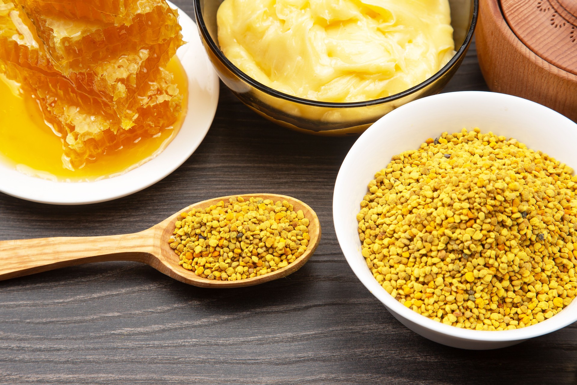 Fresh flower honey in a wooden bowl, spoon and honeycomb. vitamin food for health and life