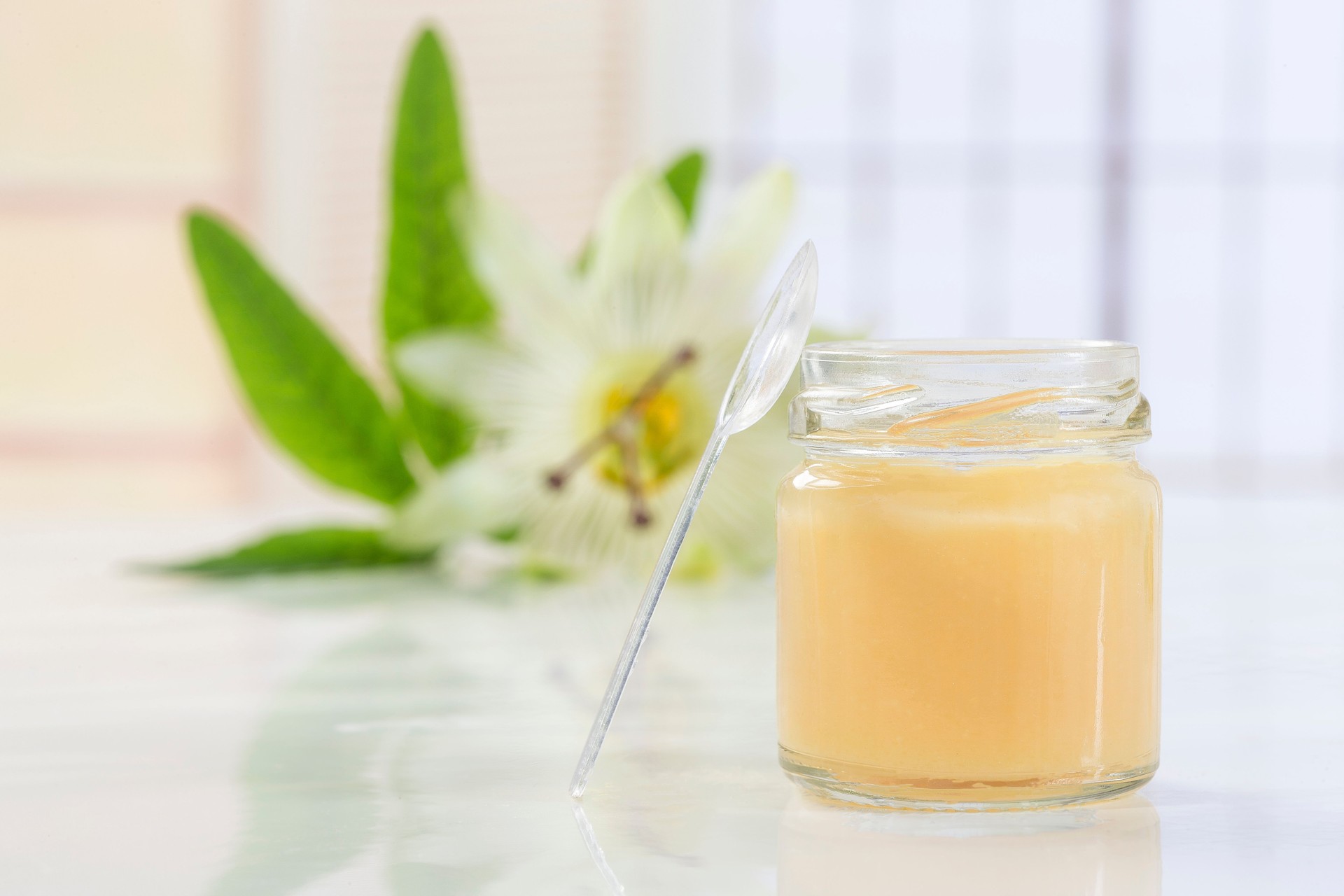 raw organic royal jelly in a small bottle with passiflora